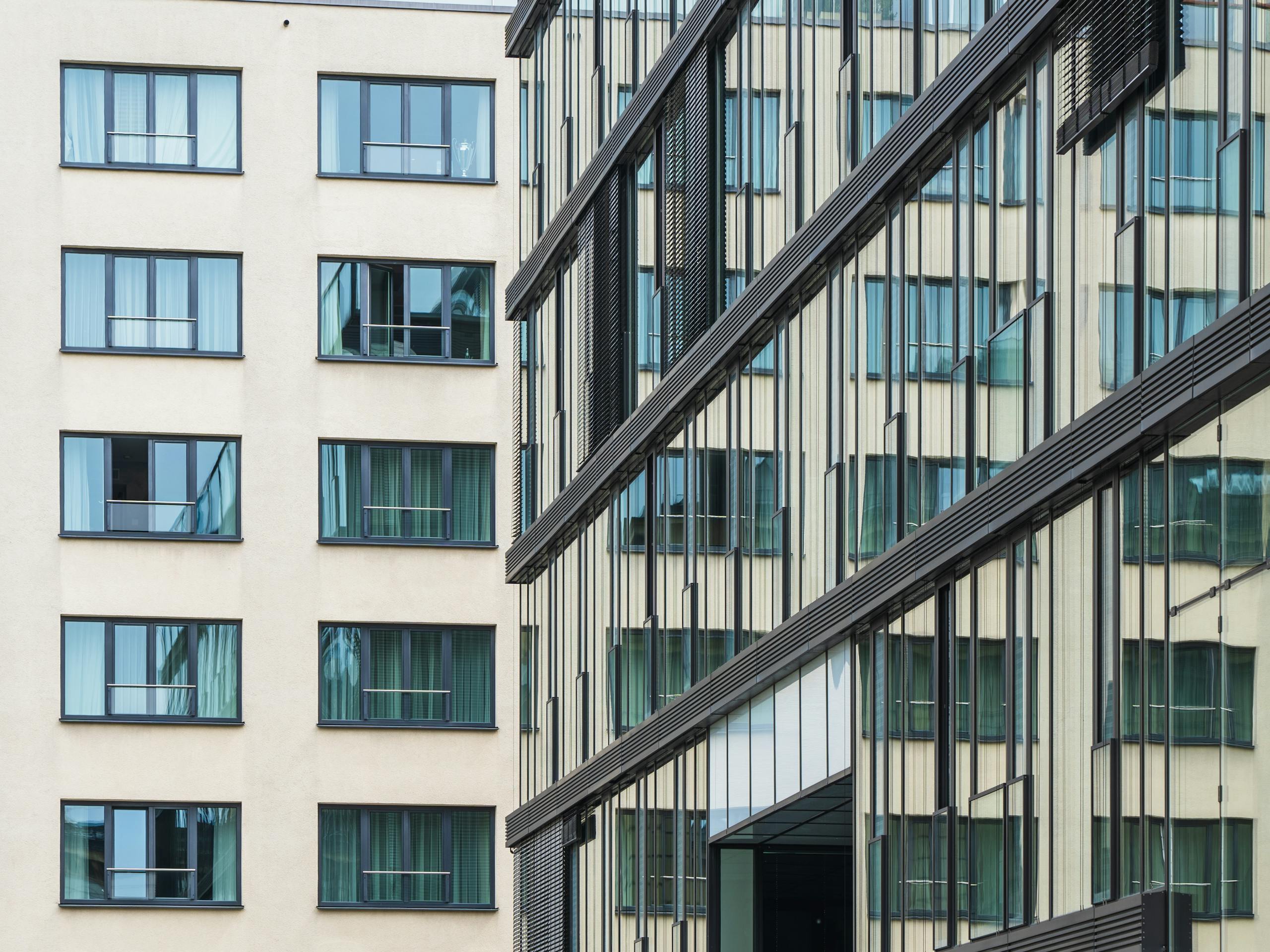 Close-up view of contemporary office and residential buildings with glass facades.