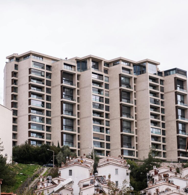 High-rise residential building in Izmir, Turkey, showcasing contemporary architecture against a cloudy sky.